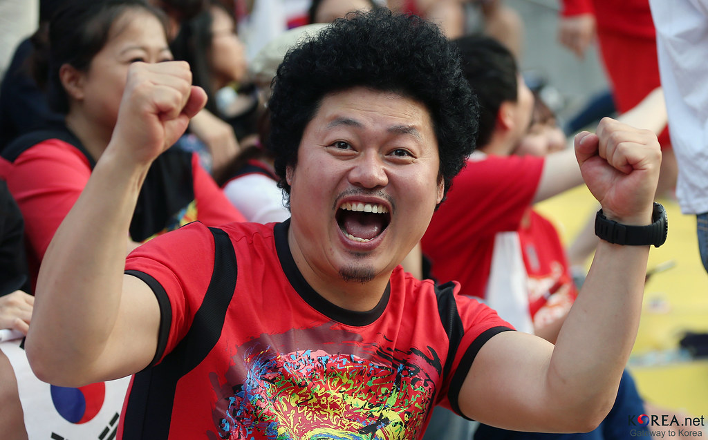 South Korea fans in red shirts watching the team