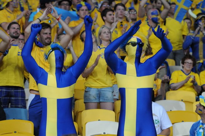 Swedish football fans waving flags in the stands