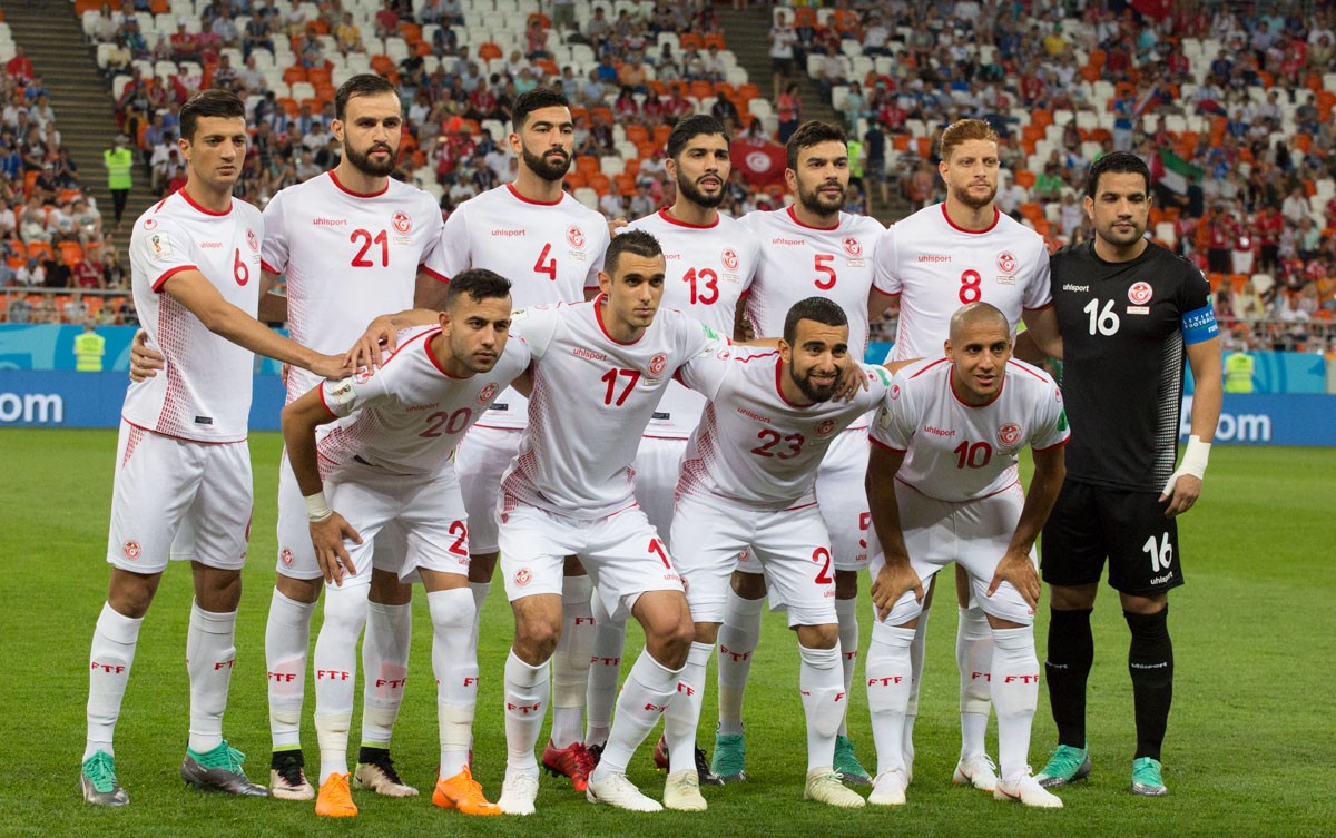 Tunisia's starting eleven lined up before a World Cup match in their white and red kit